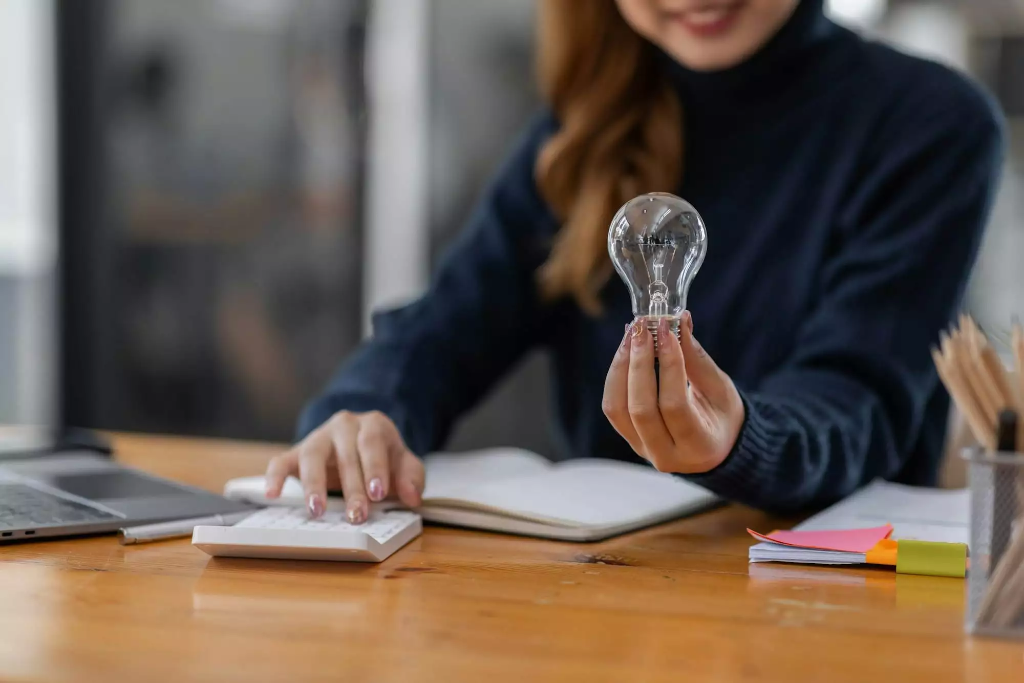 Business women hand holding light bulb, concept of new ideas with innovation and creativity.