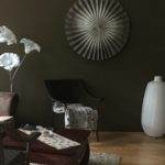 Dark color designed room with white vase and wall decorations. Stylish design