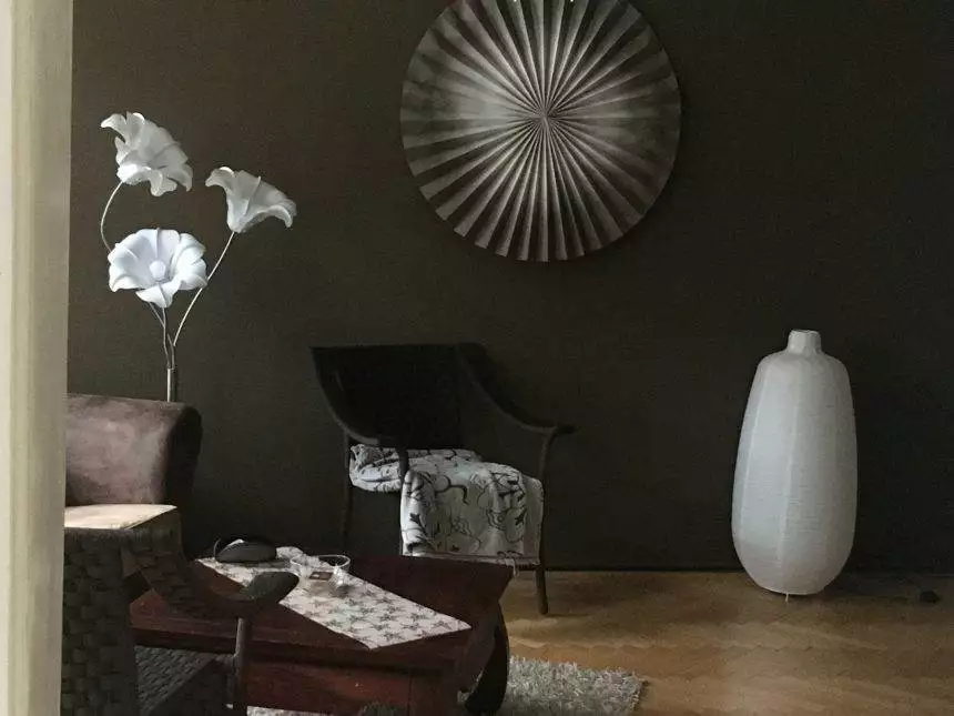 Dark color designed room with white vase and wall decorations. Stylish design