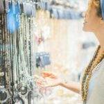 Woman looking and choosing jewelry and accessories to wear for the evening night life