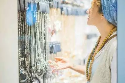 Woman looking and choosing jewelry and accessories to wear for the evening night life